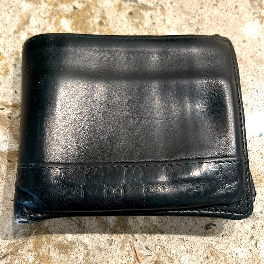 Heavily used GUCCI MEN’s bi-fold wallet in black with guccissima prints.